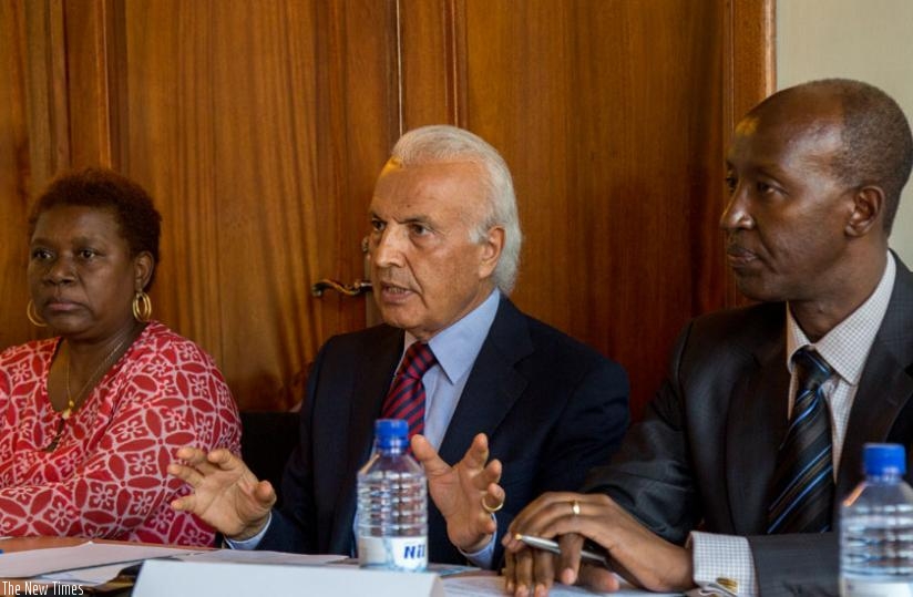 Saber (C) briefs the media about the funding deal as Ruvebana (R) and Marie Gladys Guerrier Archange, Plan International country director, listen. (Doreen Umutesi)