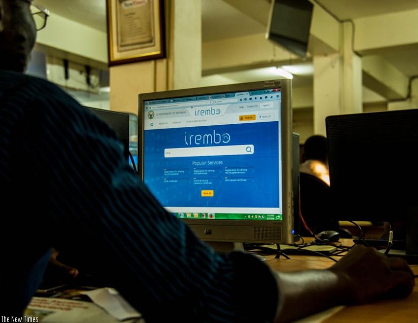 A man browses Irembo site. (Timothy Kisambira)