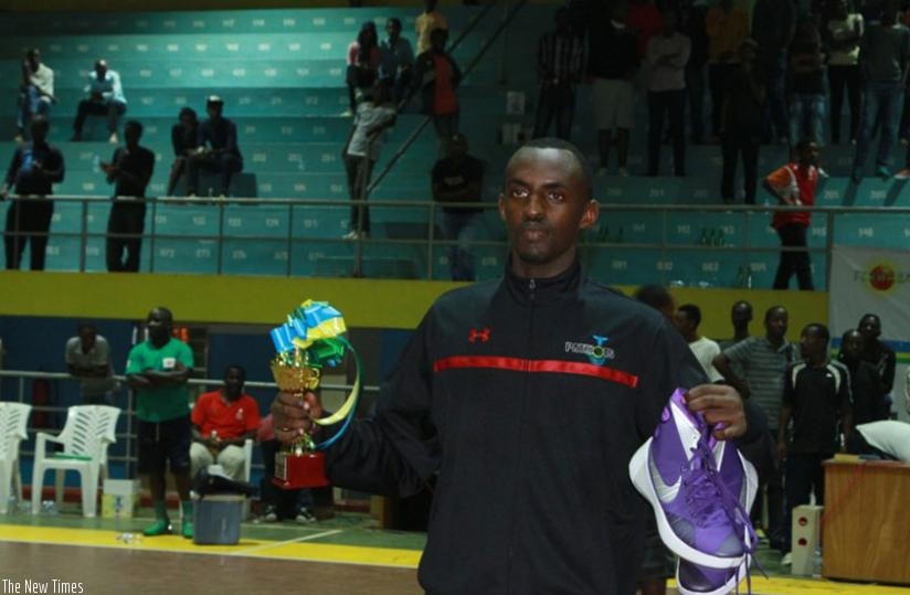 Patriots' and former Espoir playmaker Arstide Mugabe shows off his MVP awards after his side Patriots beat Espoir in the final on Monday. (Elise Mpirwa)