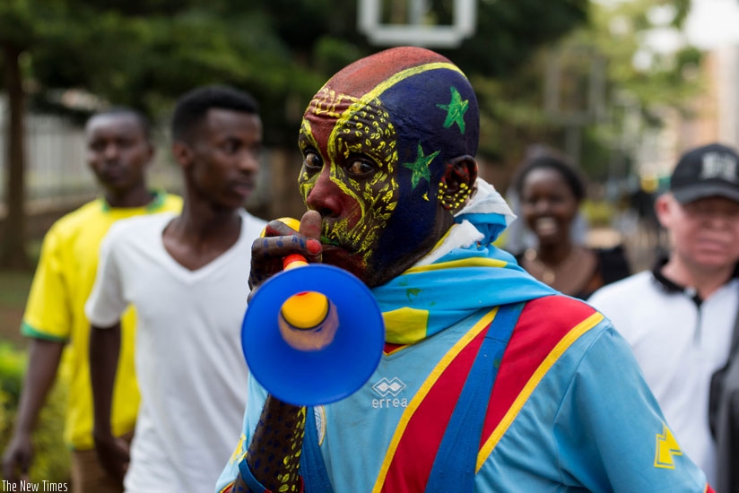 A Congolese fan blows a vuvuzela on his way to the stadium last week. (Timothy Kisambira)