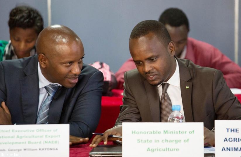 NAEB chief executive George W. Kayonga (L) chats with Nsanganira at the meeting. (T. Kisambira)