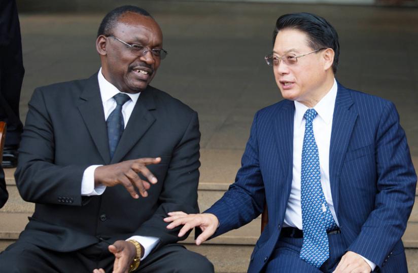 The Director-General of UN Industrial Development Organisation, Li Yong chats with Trade and Industry minister Francois Kanimba  after the signing of the cooperation agreement in Kigali yesterday. (Timothy Kisambira)