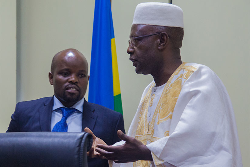 Youth and ICT Minister Jean-Philibert Nsengimana (L) chats with deputy speaker Mukama Abbas yesterday at Parliament. (Faustin Niyigena)