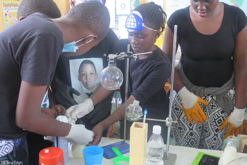 Students during an experiment. Such activities will help students perform better in class. (File)