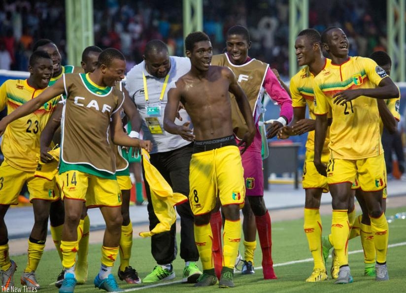 Yves Bissouma (shirt-less) leads his teammates in celebrations after scoring  the only goal in Mali's 1-0 win over Ivory Coast 1-0. (Timothy Kisambira)