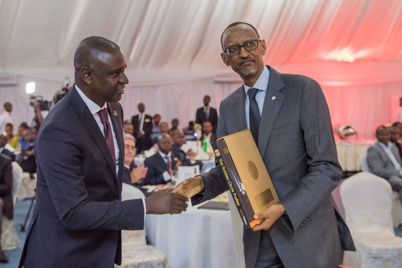 President Kagame with the Chairperson of the Private Sector Federation, Benjamin Gasamagera, during last evening's function. (Village Urugwiro)