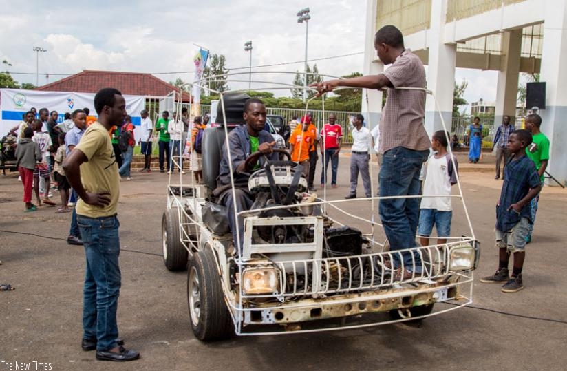 Eric Hakizimana, a teacher at EMVTC, a vocational school in Kigali, showcases a prototype car assembled by his students during the 2015 Youth Connect in Remera. (File)