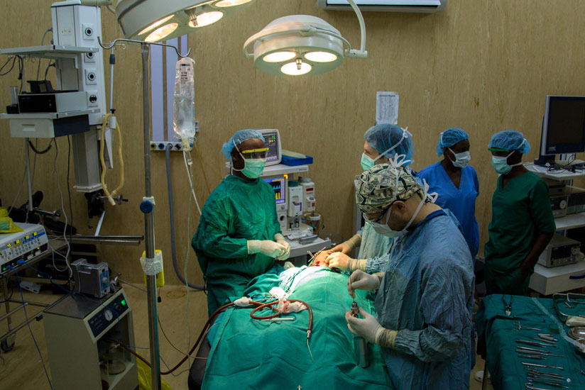International doctors helped by a local doctor carry out an operation at Rwanda Military Hospital yesterday. (Timothy Kisambira)