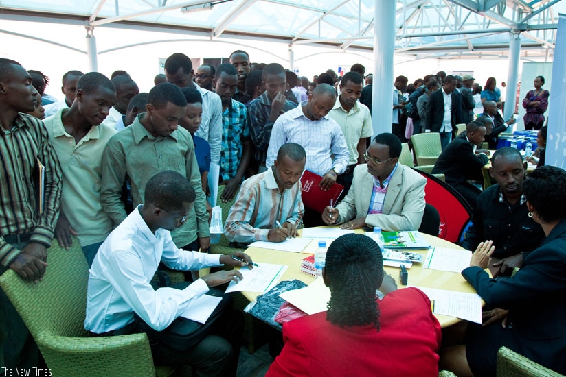 Youth fill in job application forms on Job Day last week. Government announced this week a new recruitment exercise in public service known as e-Recruitment. (Timothy Kisambira)