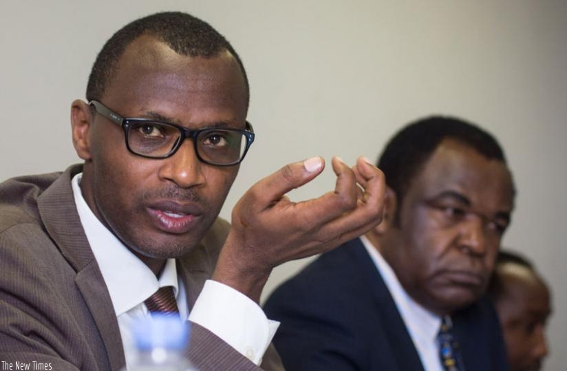 Education minister Papius Malimba Musafiri speaks to legislators as George Njoroge, the Principal of University of Rwanda's College of Education, looks on. (Timothy Kisambira)