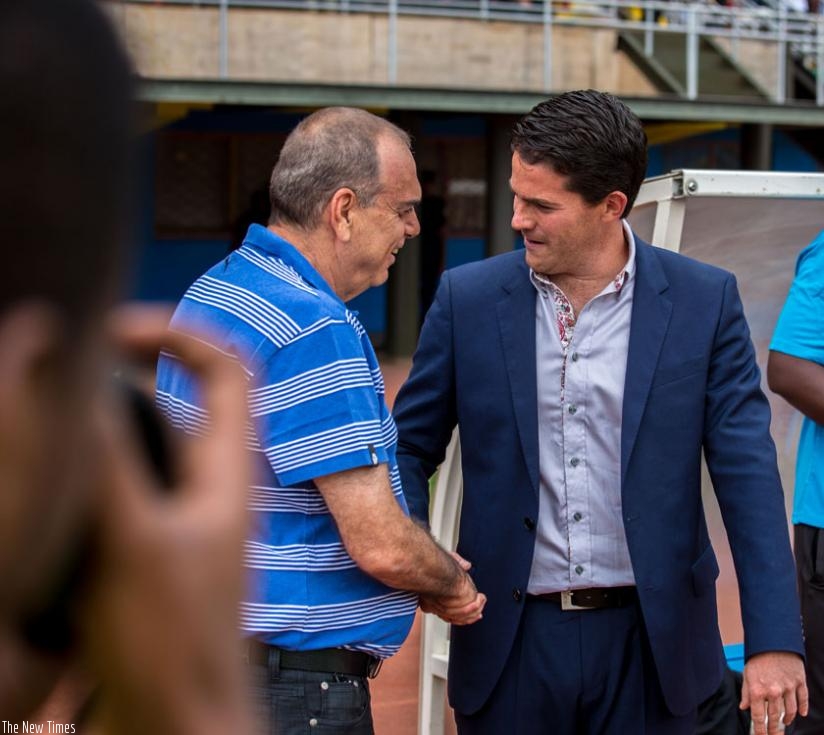 McKinstry (right) shaking hands with his Ghana counterpart Avran Grant when the two teams met in Kigali last September. (T. Kisambira)