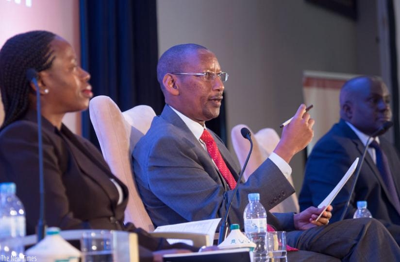 Rwangombwa (C) speaks during the monetary Policy and financial stability, as Vice Governor, Monique Nsanzabaganwa (L) and Dr Thomas Kigabo, the chief economist of the central bank looks on during a meeting in Kigali yesterday. (Timothy Kisambira)