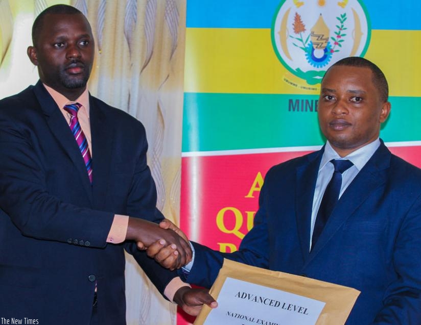 Rwamukwaya (R) hands over S6 exam results to Rwanda Education Board director Janvier Gasana. (Faustin Niyigena)