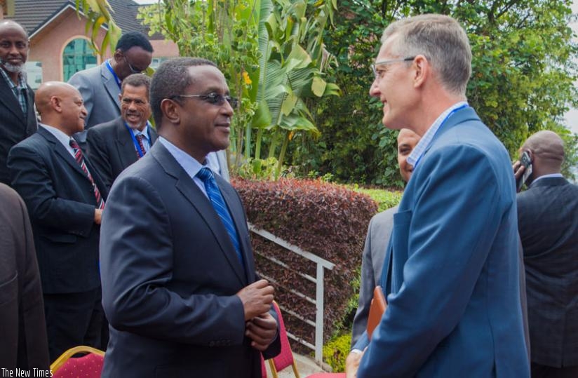 minister Biruta (L) chats with Chip Bury, the regional coordinator for USAID, which finances the GHACOF conference. (Faustin Niyigena)