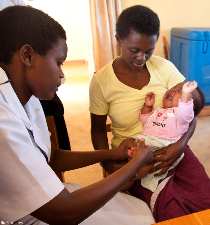 A nurse Immunises a child at Busanza Health center in Kanombe. (File)