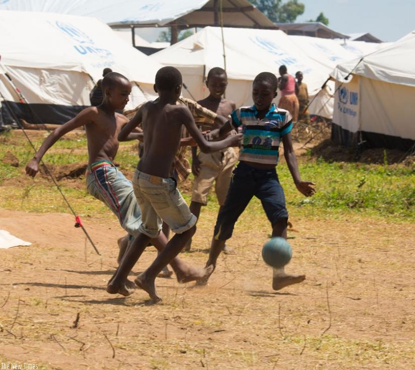 Children play football at Mahama refugee camp. (Timothy Kisambira)