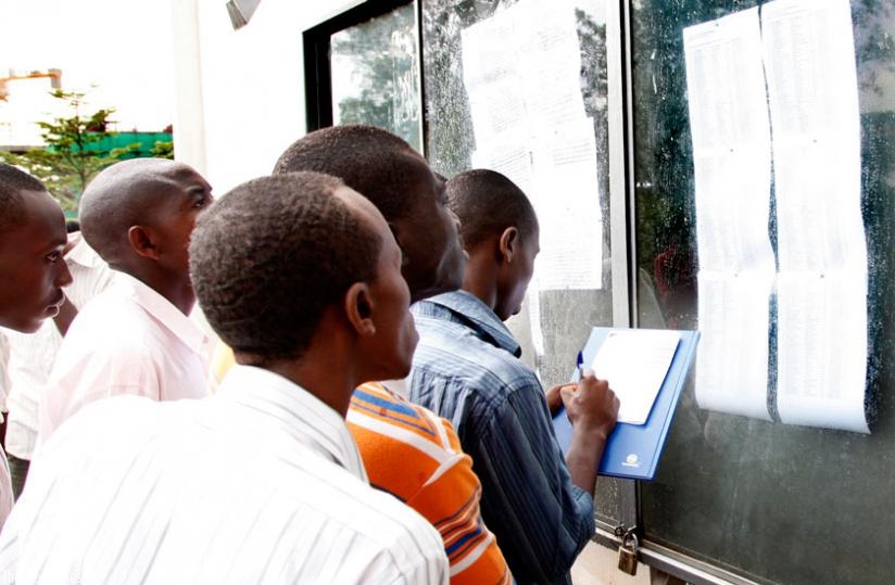 Students of UR's College of Business and Economics check for their results at the notice board. (File)