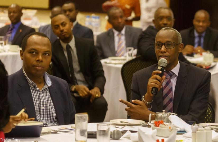 The Chief Executive of Private Sector Federation, Stephen Ruzibiza (L), speaks as Rwanda Development Board chief executive Francis Gatare looks on during a breakfast meeting with the business community in Kigali yesterday. (Timothy Kisambira)
