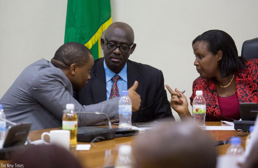 Olivier Rwamukwaya, the State Minister for Primary and Secondary Education (L),chats with Minister Gasinzigwa,(R) as Justice minister, Johnstone Busingye (C) looks on. (Timothy Kisambira)