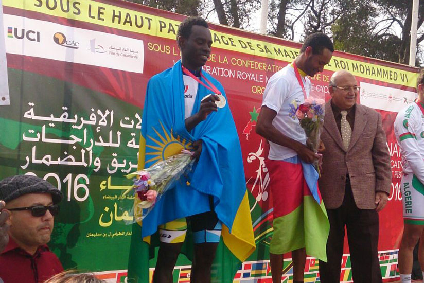 Uwizeye (left with Rwandan flag) shows off his silver medal. (Courtesy)