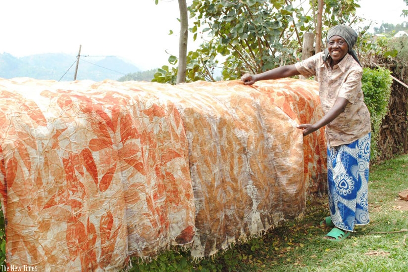 A lady displays some of her finished pieces of cloth made out of natural dye. (Pontian Kabeera)