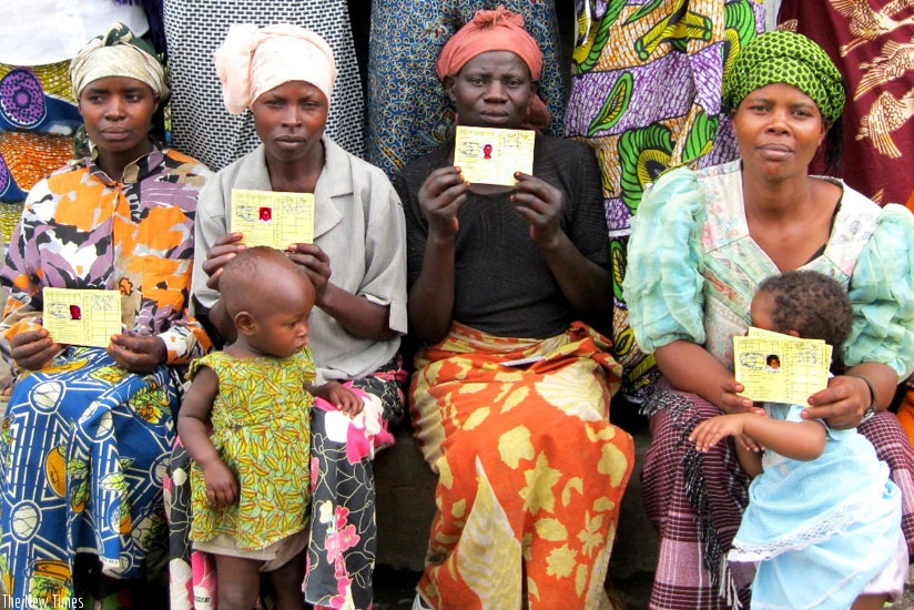 A group of mothers display their Mutuelle de Sante cards. The government will pay accumulated debts owed to hospitals, health centres and other stakeholders, something that will lead to better service delivery. (File)