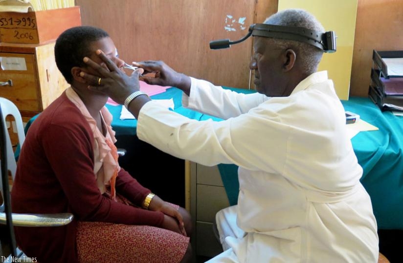 Dr Ntabomvura examines a patient at CHUB in  Huye District on Tuesday. (Emmanuel Ntirenganya)
