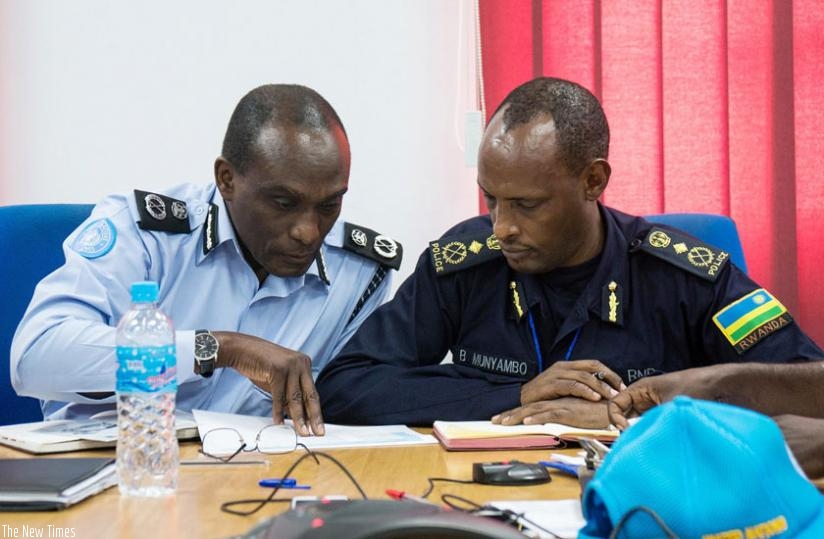 Outgoing UNMISS police commander Yiga compare notes with his successor Munyambo. (Courtesy)