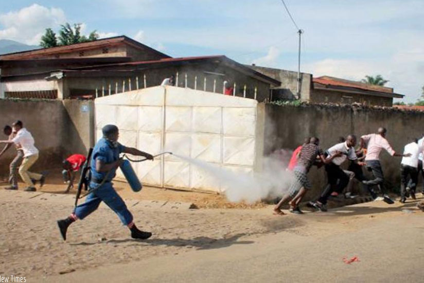 A police officer fires tear gas at protesters in Bujumbura. (Net photo)
