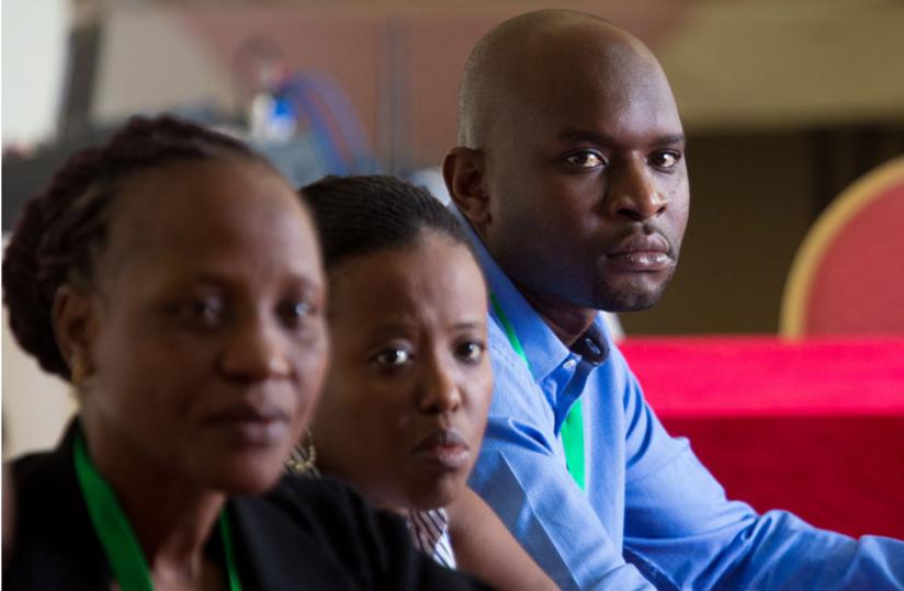 Participants follow proceedings during the meeting. (Timothy Kisambira)