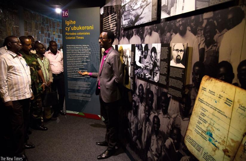 A staff of Kigali Genocide Memorial Centre in Gisozi explains to visitors about the Genocide. (T. Kisambira)