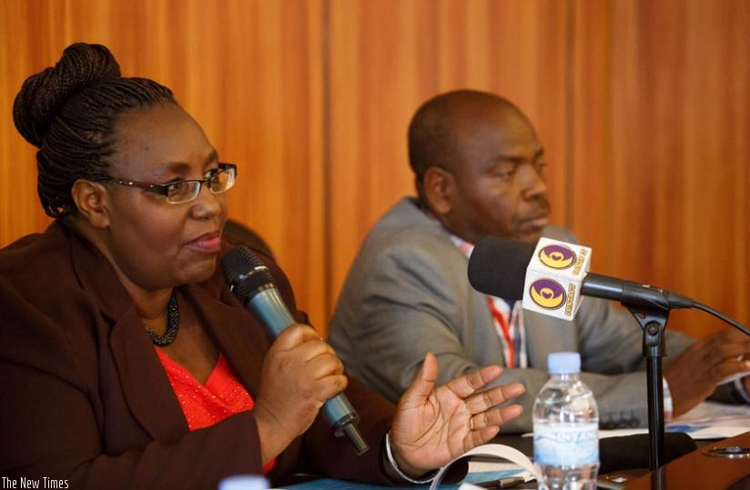 Mukantabana briefs the media as Francois Xavier Nzeyimana, an official from MIDIMAR, looks on. (T. Kisambira)