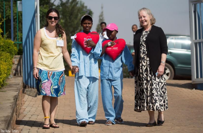 (L-R) Sara Pitmann from Team Heart (L) and and Patton-Bolman walk patients Esperance Mukakizima from Musanze (2ndL) and Marie Aimee Tuyishime from Nyaruguru after their heart surgeries at King Faisal Hospital. (Timothy Kisambira)
