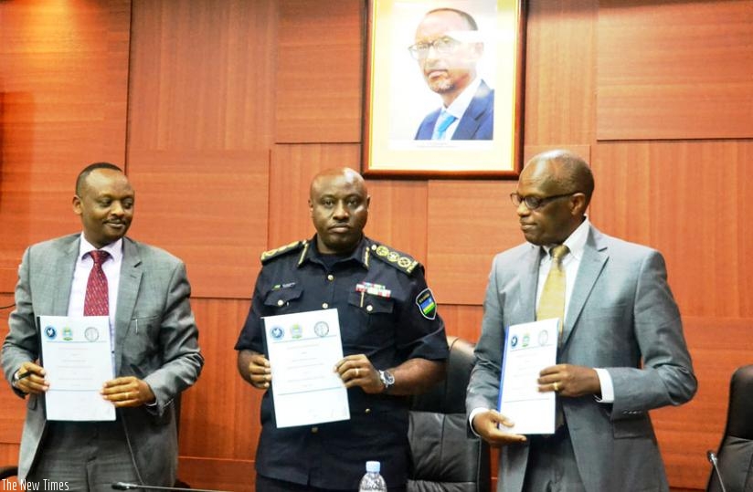 L-R; Muhumuza, IGP Gasana and Dr Rwamasirabo after signing the agreement in Kigali. (Courtesy)