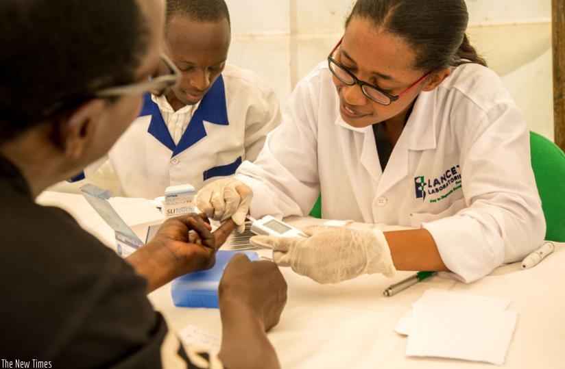 A staffer from Lancet Laboratories takes blood samples during kidney screening in Kigali yesterday. (D. Umutesi)