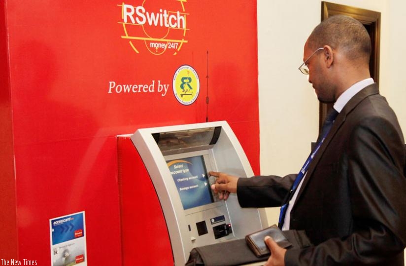 A bank customer withdraws money from an RSwitch-operated ATM. (File)