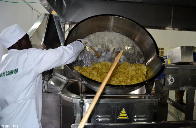 A worker oversees the production of chips at the new processing plant. (JD Mbonyinshuti)