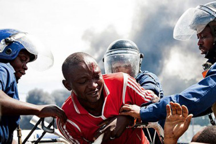 Burundian Police arrest a protester. (Net Photo)