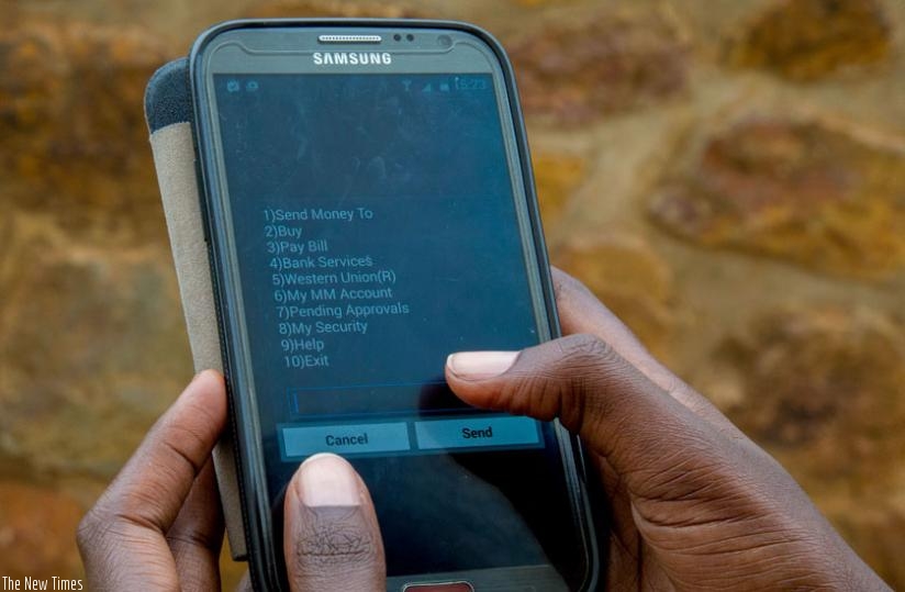 A customer uses Mobile Money to make a transaction. This has been used as one of the strategies to boost financial inclusion, but it also facilitates easy transactions of various kind, thus saving time. (File)