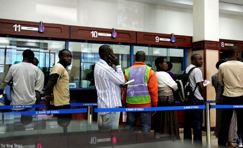 Customers queu to get service in a banking hall at Bank of Kigali. (File)