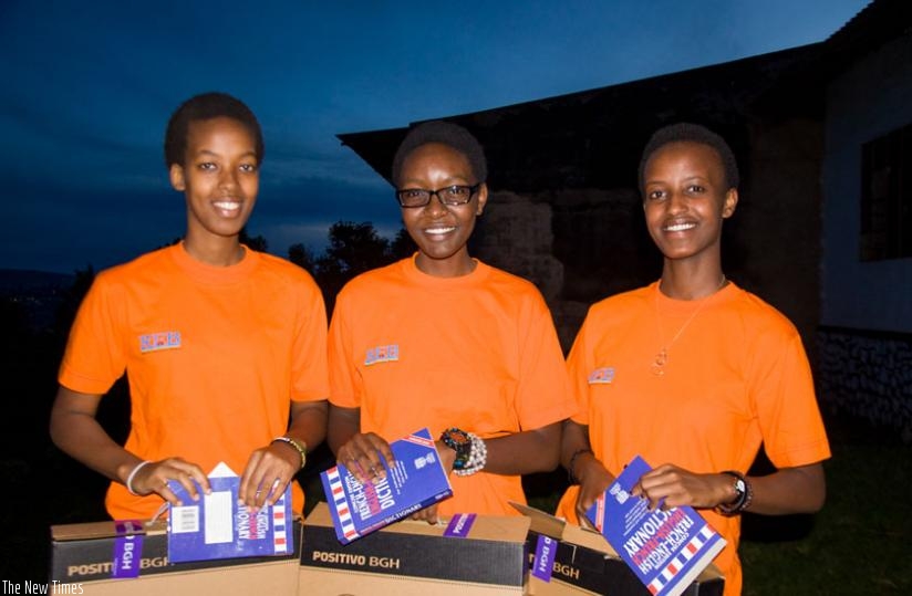 L-R; Didiane Shenge, Sandrine Mutezinka and Sandrine Ashimwe, winners of science competition, pose for a photo with some of their prizes. (Teddy Kamanzi)