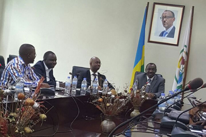 The head of the National Institute of Statistics of Rwanda, Yusuf Murangwa, (2nd R) flanked by Finance minister , Claver Gatete (R) (Photo by Bryan Kimenyi)