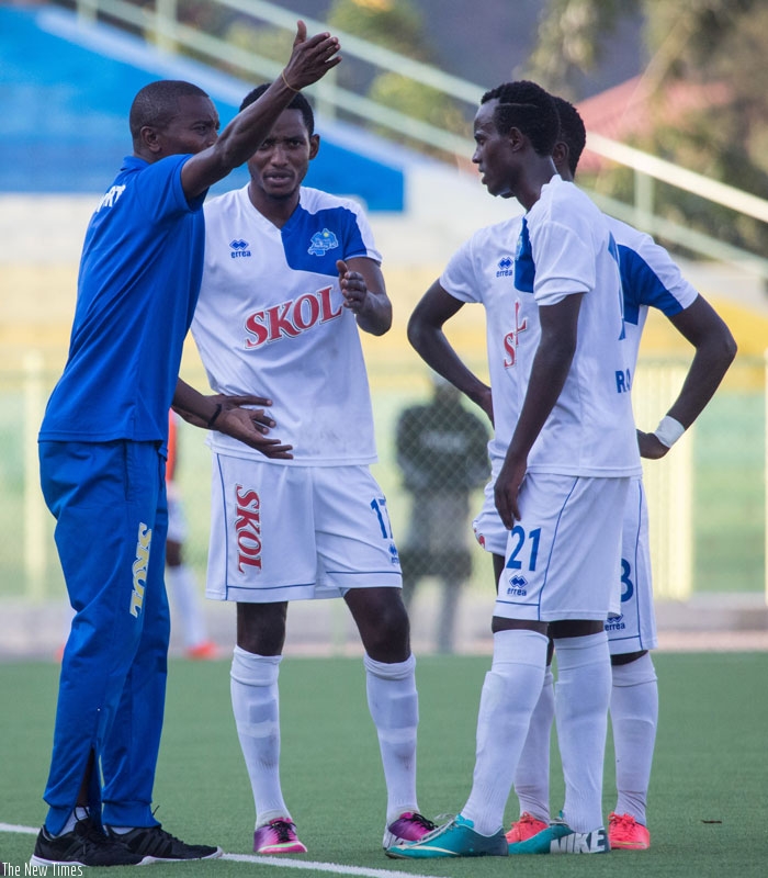 Rayon Sports interim coach Masudi, left, gives instructions to his players during a league match against AS Muhanga. (T. Kisambira)