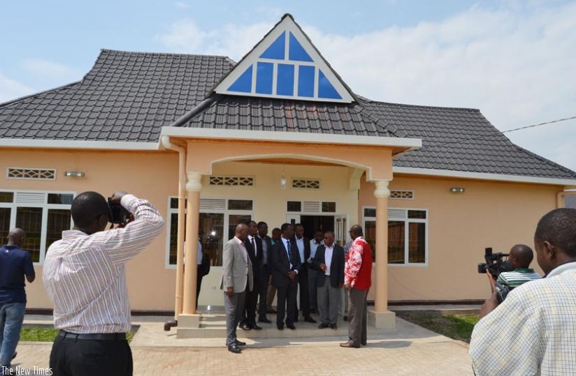 Officials in front of one of the new housing units in Musanze. (Jean d'Amour Mbonyinshuti)