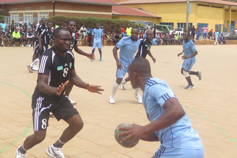 Police's Jean-Paul Muhawenayo (with the ball) looks to go past APR's Viateur Rwamanywa last season. (Stephen Kalimba)