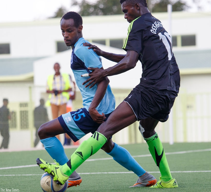 Rashid Kalisa of Police FC (L) vies for the ball with Mathias Osagatsama of Vita Club Mokanda at Stade de Kigali yesterday. Police lost 1-0. (Timothy Kisambira)