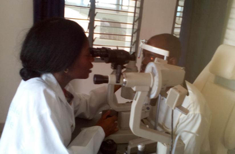 Dr Sebuseruka examining a patient with an eye problem. (Lydia Atieno)