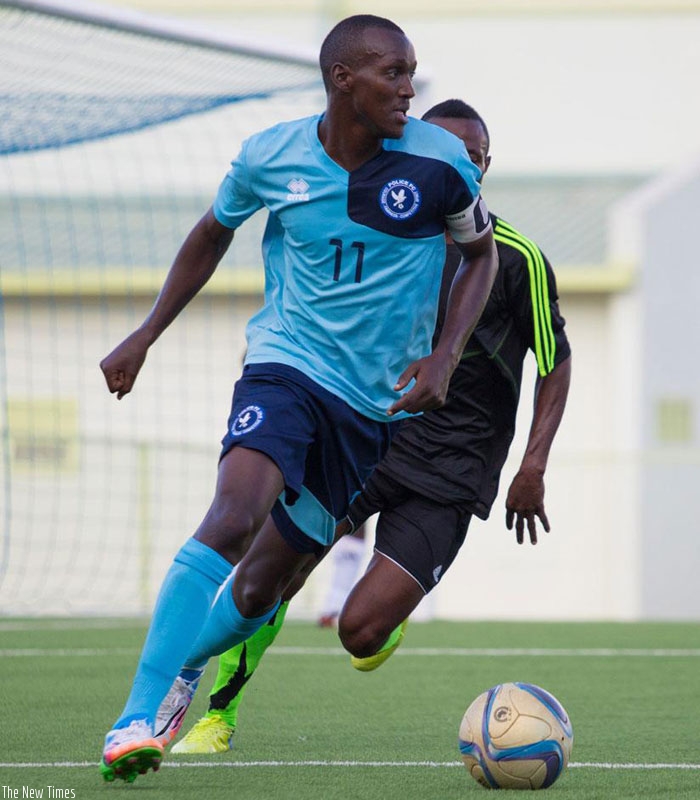 Police FC team captain Innocent Habyarimana runs with the ball past a Vita Club Mokanda player during th return leg on Saturday. (T. Kisambira)