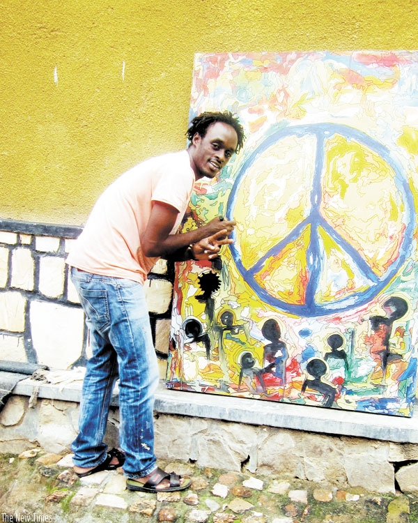 Innocent Buregeya working on an art piece; his art has some cryptic messages behind it when studied closely. (J. Oindo)