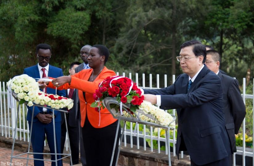 Sports and Culture minister Julienne Uwacu (L) and Zhang lay wreaths at Kigali Genocide Memorial Centre yesterday. (T. Kisambira)